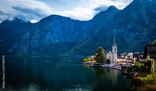 Dramatic evening scenery of high rocky mountains and Hallstatt city at the wide lake © Ievgen Skrypko