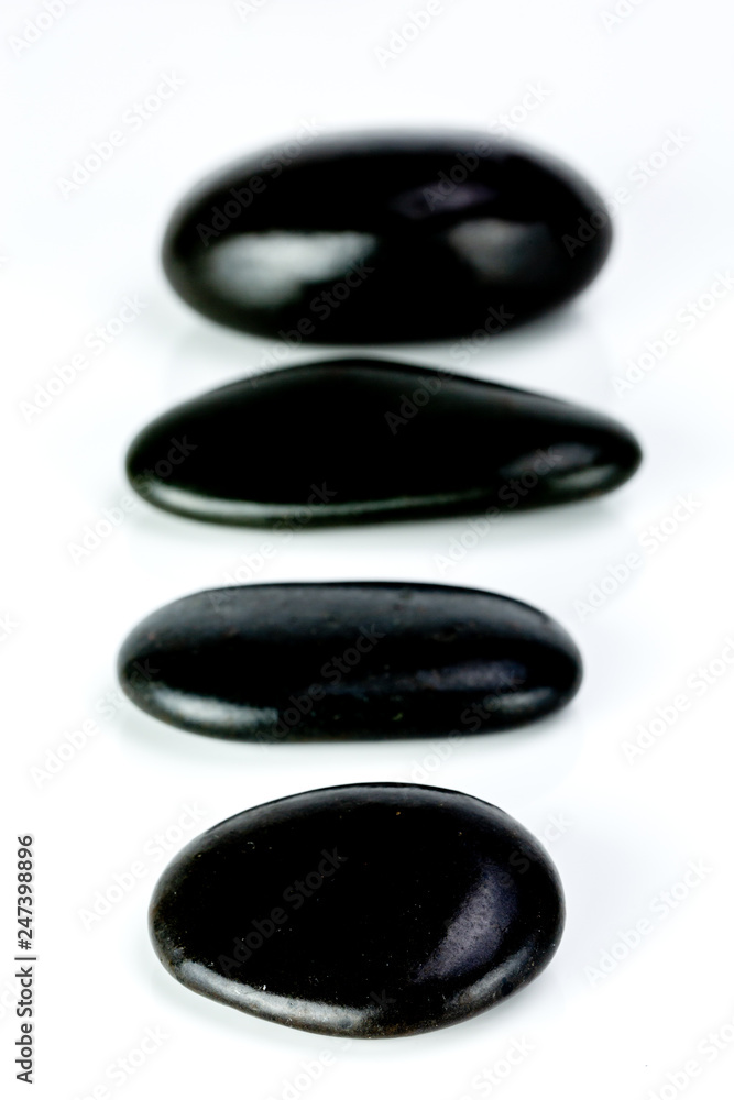Black Stones aligned on a white background Black Stones aligned on a white background