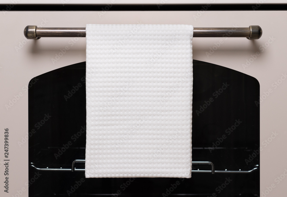 White kitchen towel hangs on the oven handle, product mockup Stock Photo |  Adobe Stock