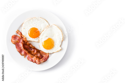Fried eggs and bacon for breakfast isolated on white background.Top view. Copyspace