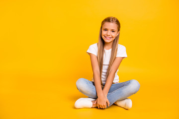 Portrait of her she nice cute sweet attractive cheerful straight-haired pre-teen girl sitting in lotus pose isolated over bright vivid shine yellow background
