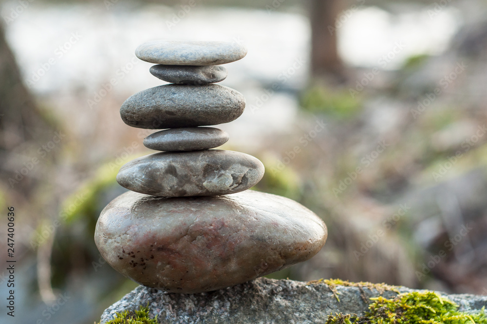 Closeup of stone balance on rock in border river Closeup of stone balance on rock in border river