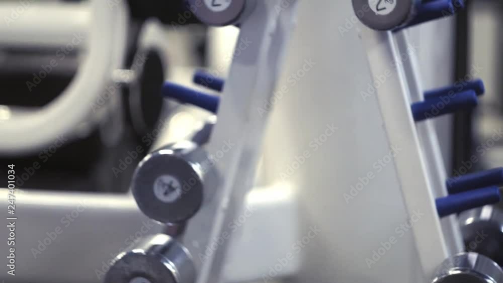 Man hand grab a Heavy Duty Dumbbell from the stand in the gym Man hand grab a Heavy Duty Dumbbell from the stand in the gym