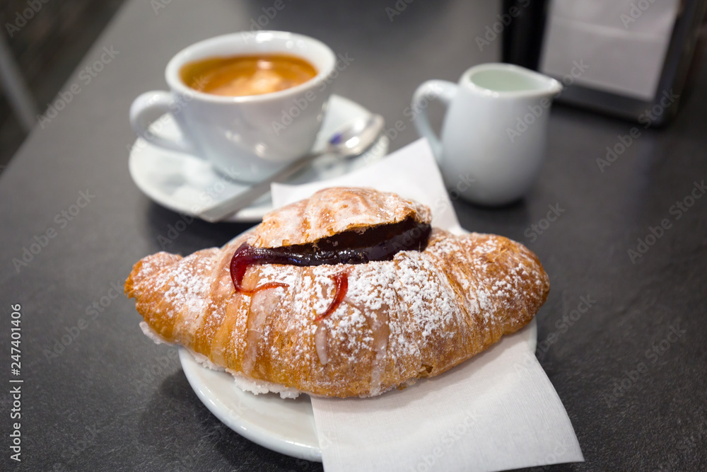 Italian coffee with jam croissant on the table