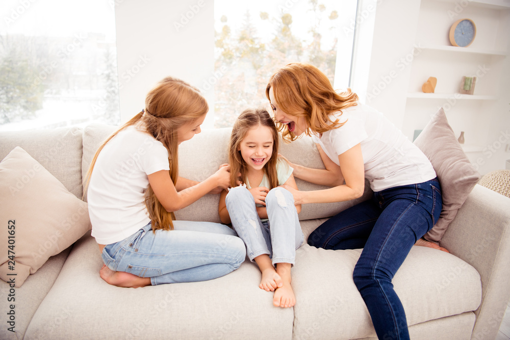 Portrait of nice cute lovely attractive adorable cheerful cheery positive funny funky blonde hair  people mom mommy mum pre-teen girls playing on divan rejoicing in house indoors