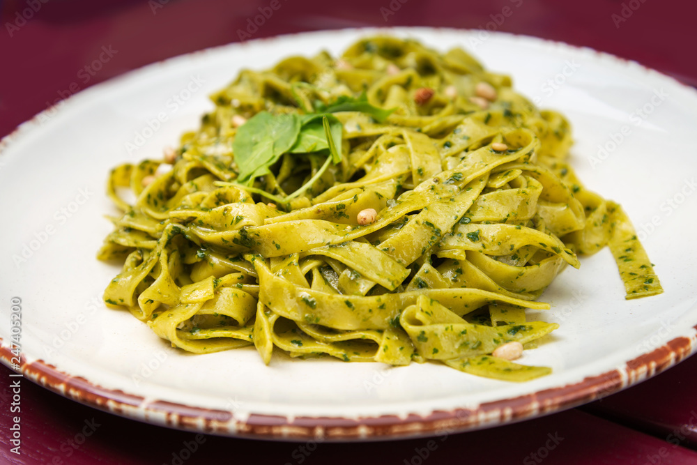 Pasta with pesto sauce and nuts on a the table Pasta with pesto sauce and nuts on a the table