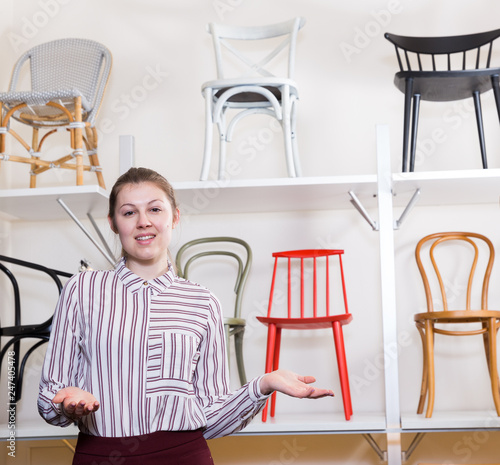 Salesgirl inviting to visit chair salon photo