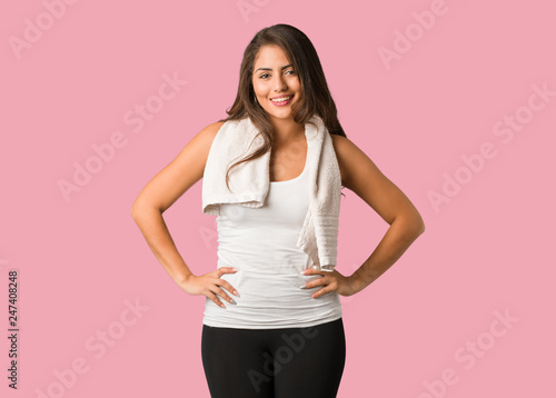 Full body young fitness curvy woman with hands on hips