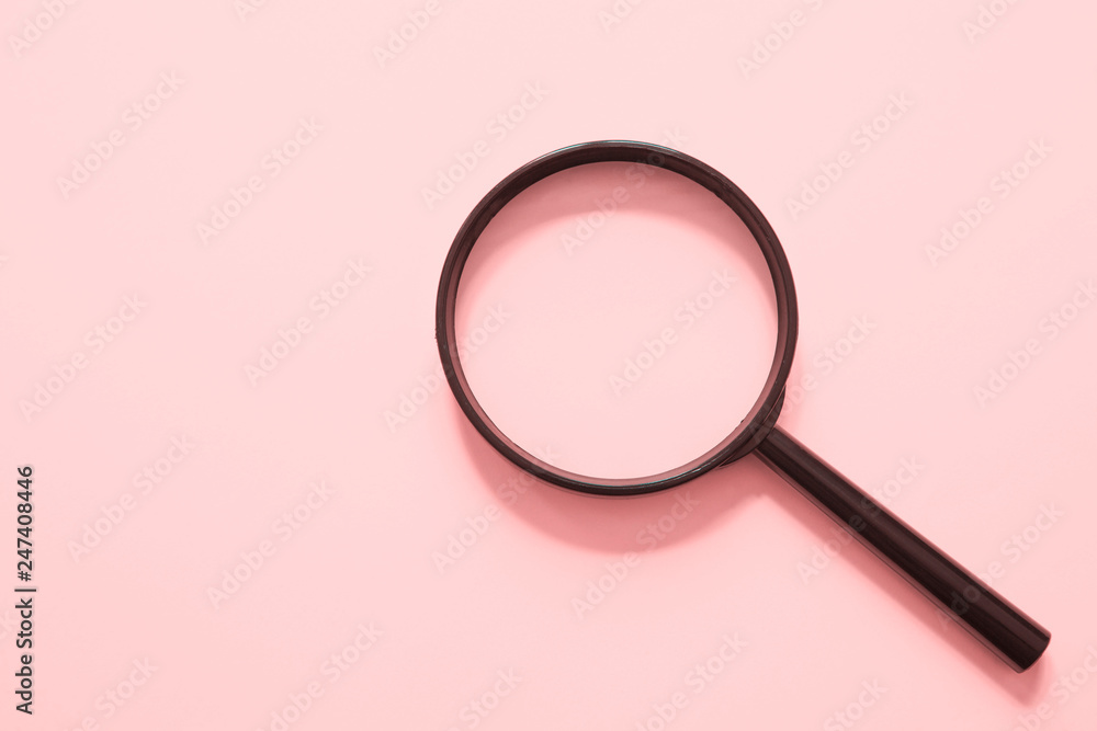 İsolated magnifier on pink background İsolated magnifier on pink background