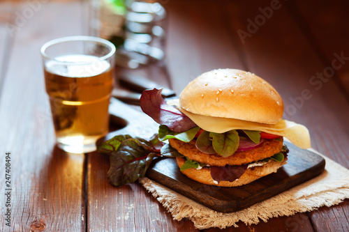 Fresh spicy grilled hamburger on a rustic wooden table