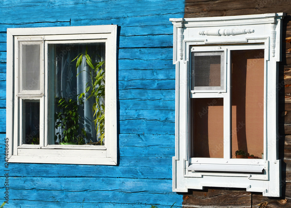 Fototapeta premium two carved windows in a half-dwelling house