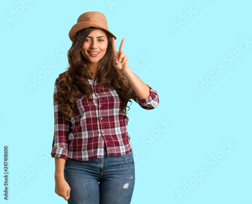 Full body young traveler curvy woman showing number two