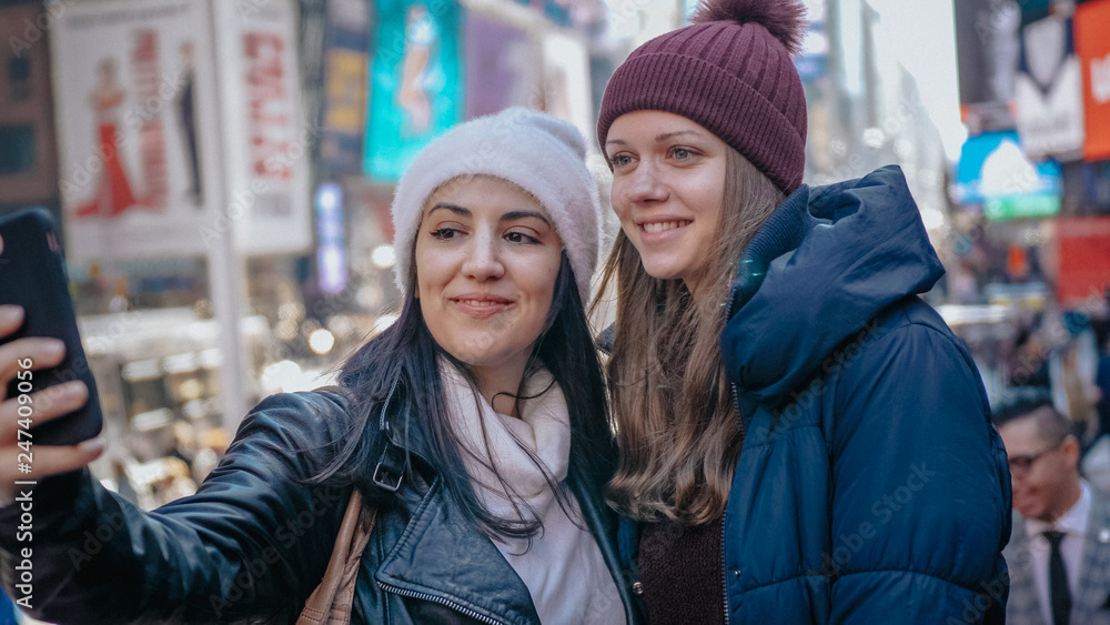 Two friends at Times Square New York for sightseeing Two friends at Times Square New York for sightseeing