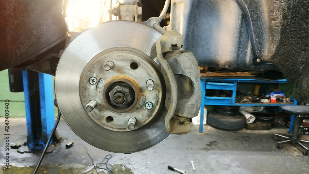 Car brake part at garage,car brake disc without wheels closeup