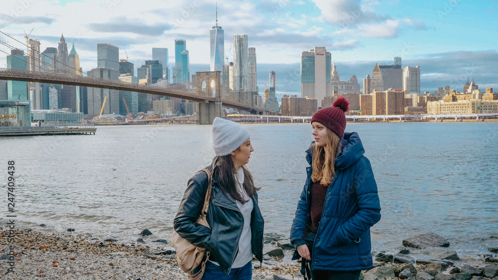 Two young women in New York enjoy the breathtaking Manhattan Skyline