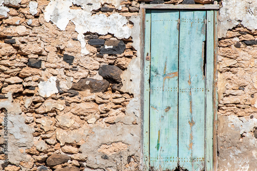 Old stone wall and wooden door Old stone wall and wooden door