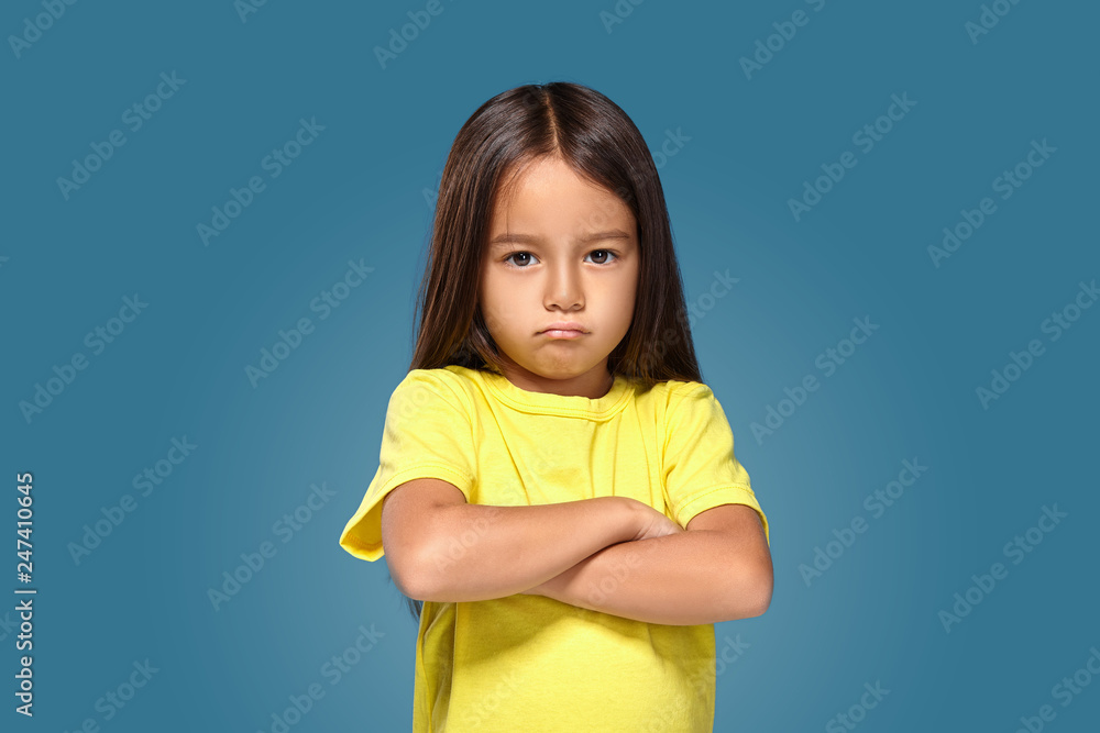 Angry little kid showing frustration and disagreement