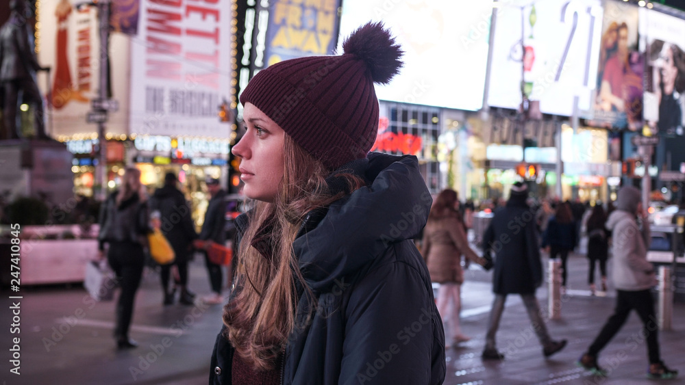 Walking on Times Square New York by night while doing a sightseeing trip to Manhattan Walking on Times Square New York by night while doing a sightseeing trip to Manhattan