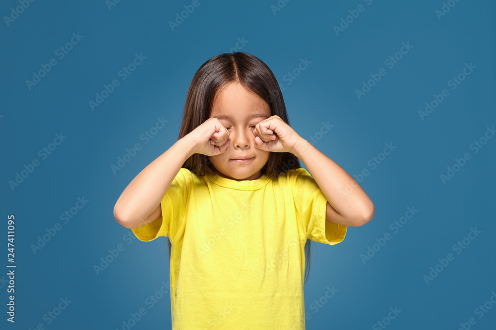 Sad offended little girl cries in yellow t-shirt Sad offended little girl cries in yellow t-shirt