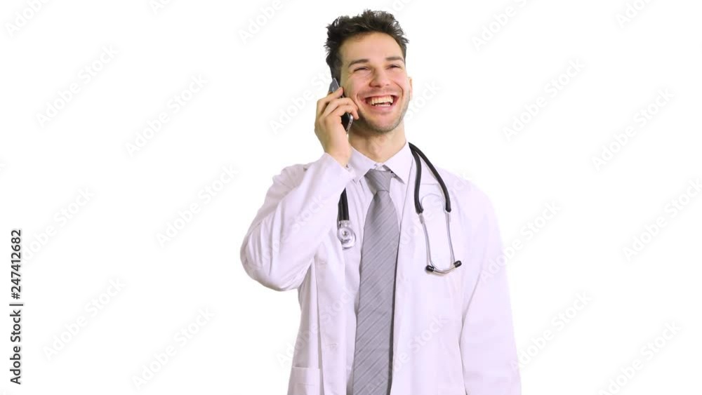 Handsome man doctor isolated on white background talking on smartphone, smiling positively Handsome man doctor isolated on white background talking on smartphone, smiling positively