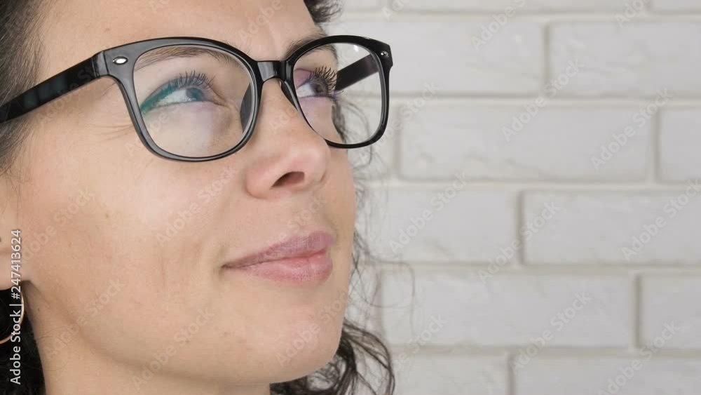 Woman wearing glasses looking around. Pretty woman in glasses looks up. Woman wearing glasses looking around. Pretty woman in glasses looks up.