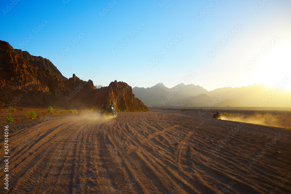 Desert road and  quadricycles