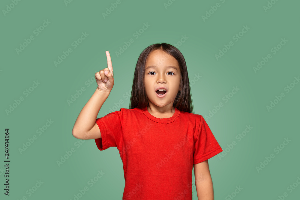 Little girl in red t-shirt with finger up Little girl in red t-shirt with finger up