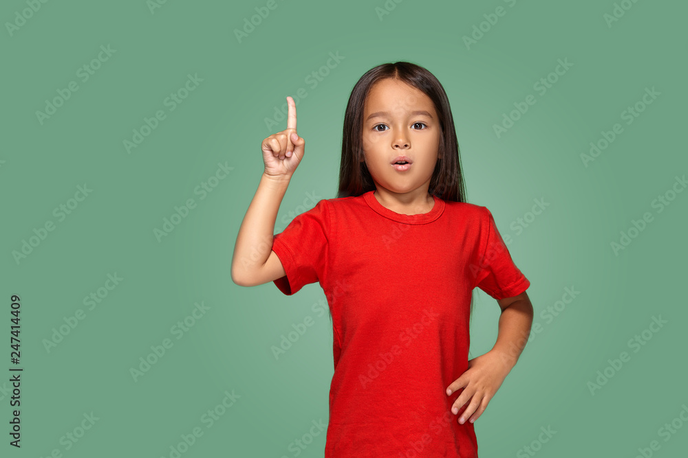 Little girl in red t-shirt with finger up Little girl in red t-shirt with finger up