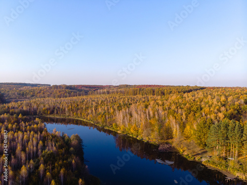 beautiful view from the drone to the lake in the forest  autumn day  multicolor trees  bright. outdoor recreation concept  in the countryside  barbecue fishing and camping