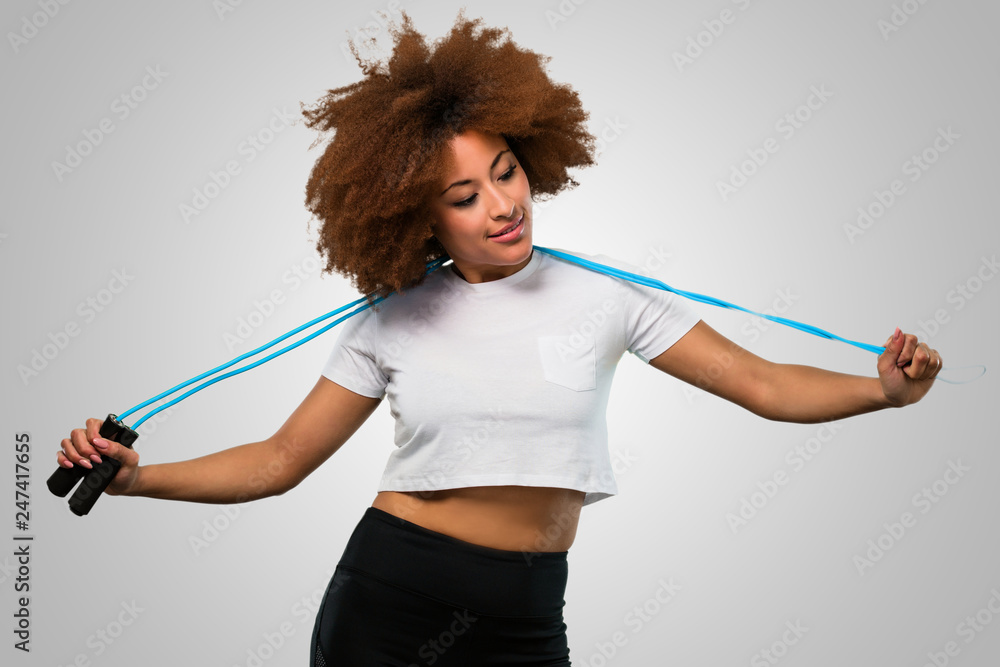 young fitness afro woman holding a skipping rope young fitness afro woman holding a skipping rope