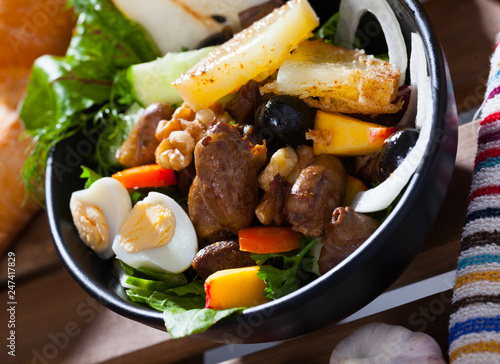 Salad with chicken hearts and quail eggs