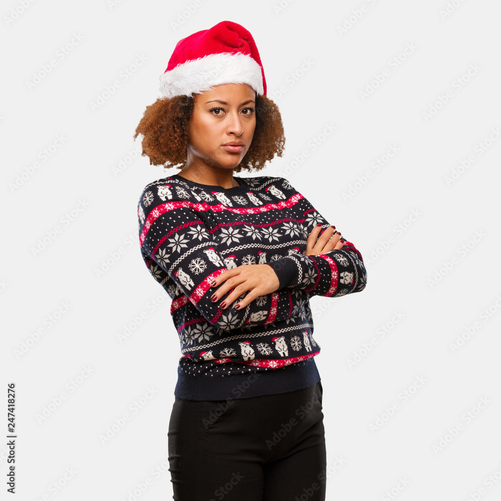 Young black woman in a trendy christmas sweater with print looking straight ahead Young black woman in a trendy christmas sweater with print looking straight ahead
