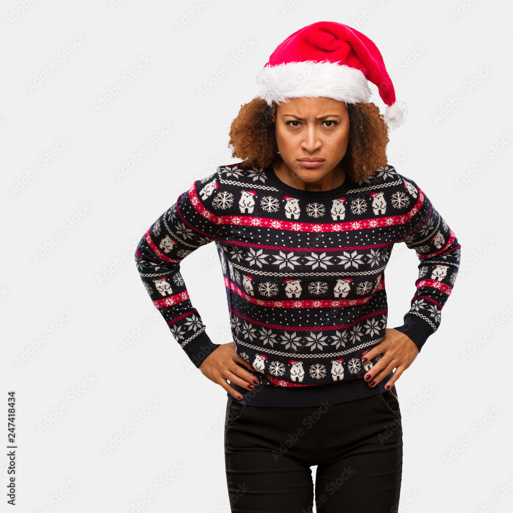 Young black woman in a trendy christmas sweater with print scolding someone very angry Young black woman in a trendy christmas sweater with print scolding someone very angry
