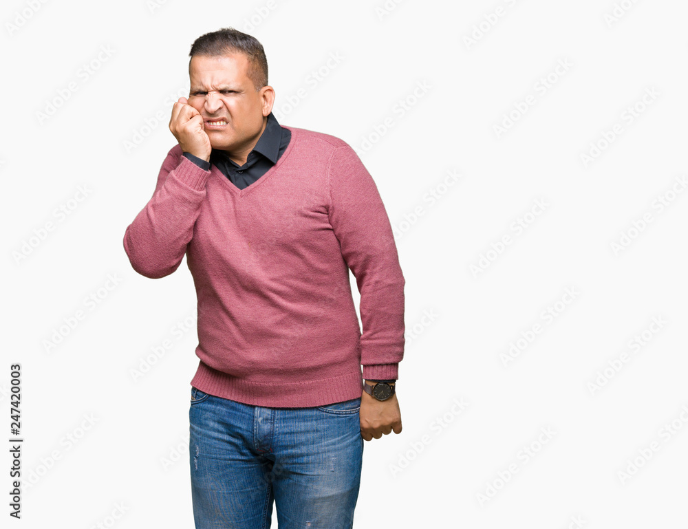 Middle age arab man over isolated background looking stressed and nervous with hands on mouth biting nails. Anxiety problem. Middle age arab man over isolated background looking stressed and nervous with hands on mouth biting nails. Anxiety problem.