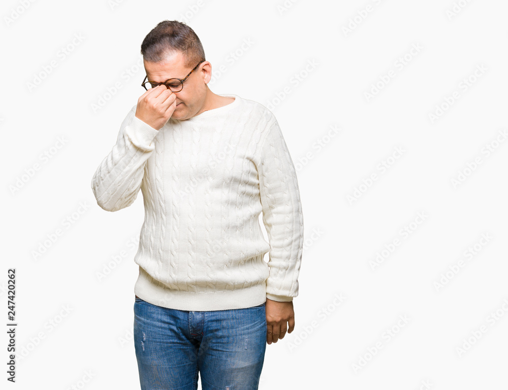 Middle age arab man wearing glasses over isolated background tired rubbing nose and eyes feeling fatigue and headache. Stress and frustration concept. Middle age arab man wearing glasses over isolated background tired rubbing nose and eyes feeling fatigue and headache. Stress and frustration concept.