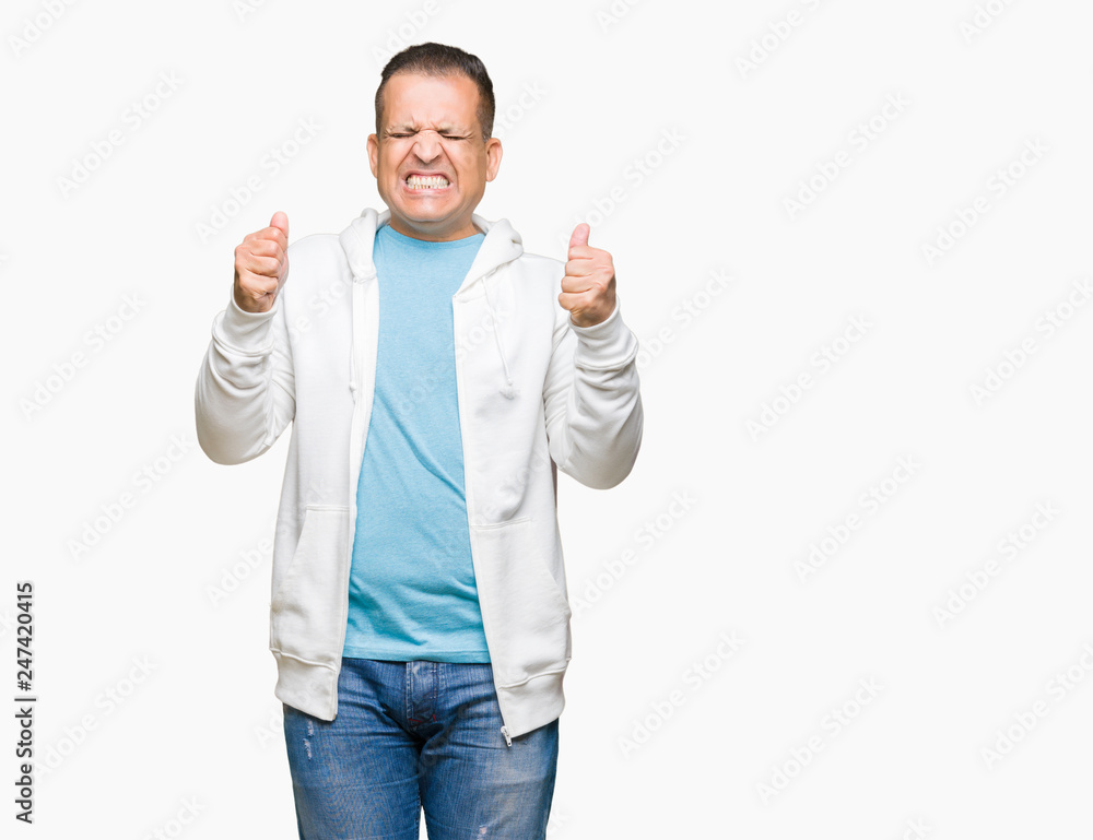 Middle age arab man wearing sweatshirt over isolated background excited for success with arms raised celebrating victory smiling. Winner concept. Middle age arab man wearing sweatshirt over isolated background excited for success with arms raised celebrating victory smiling. Winner concept.
