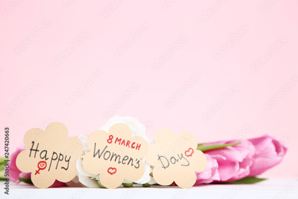 Text Happy Women's Day with flowers on pink background