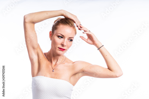 Caucasian white female model portrait. Beautiful girl, long red hair. Woman posing studio shot on a white background