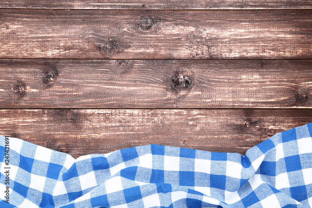 Blue napkin on brown wooden table Blue napkin on brown wooden table