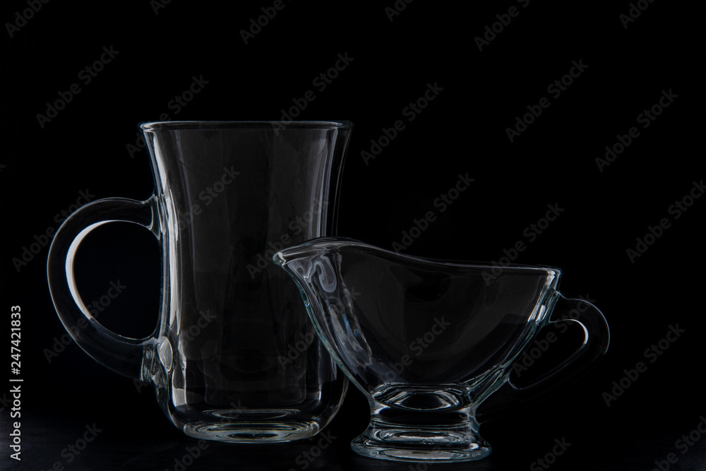 crockery for making coffee, a cup and milk jug. Black background crockery for making coffee, a cup and milk jug. Black background