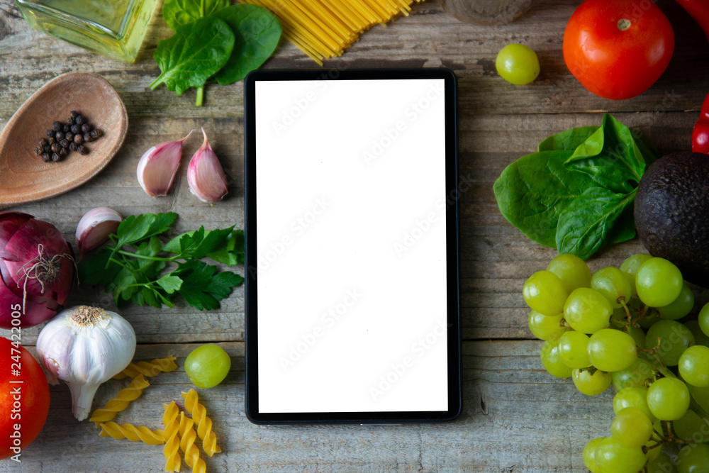 diet plannig. Set of raw food with tablet on wooden background with gadget screen with copy space. Healthy food concept, top view. Healthy food concept. diet plannig. Set of raw food with tablet on wooden background with gadget screen with copy space. Healthy food concept, top view. Healthy food concept.