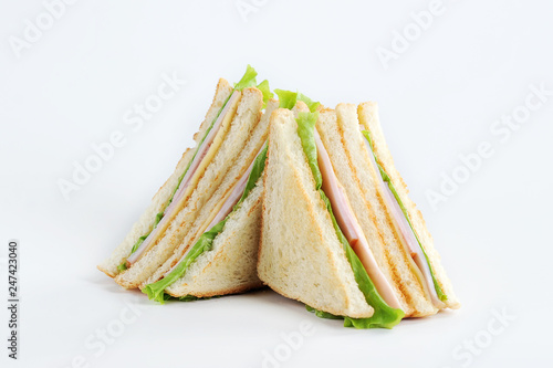 Club sandwich with cheese and party on a white background. White bread is used to make a sandwich. Close-up.