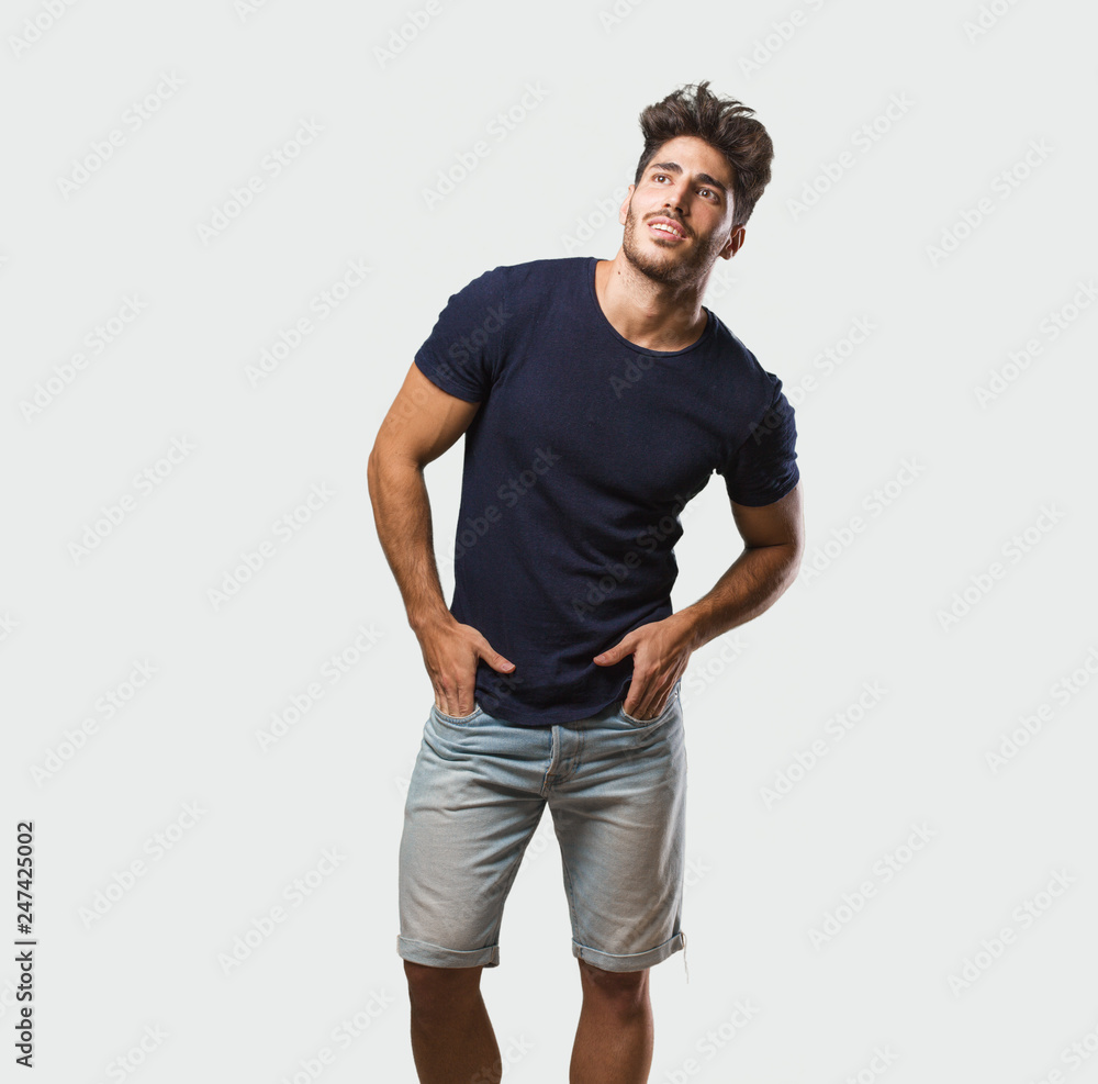 Young handsome man standing looking up, thinking of something fun and having an idea, concept of imagination, happy and excited Young handsome man standing looking up, thinking of something fun and having an idea, concept of imagination, happy and excited
