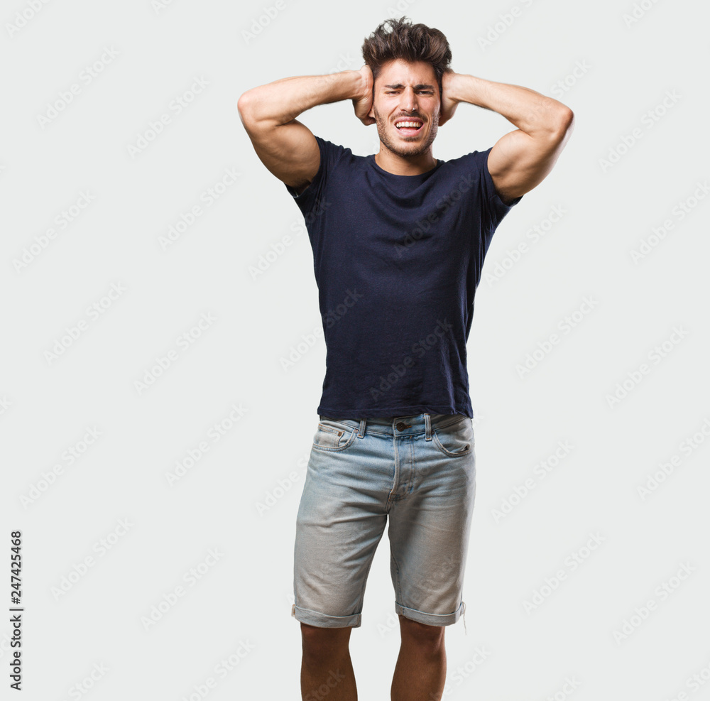 Young handsome man standing crazy and desperate, screaming out of control, funny lunatic expressing freedom and wild Young handsome man standing crazy and desperate, screaming out of control, funny lunatic expressing freedom and wild