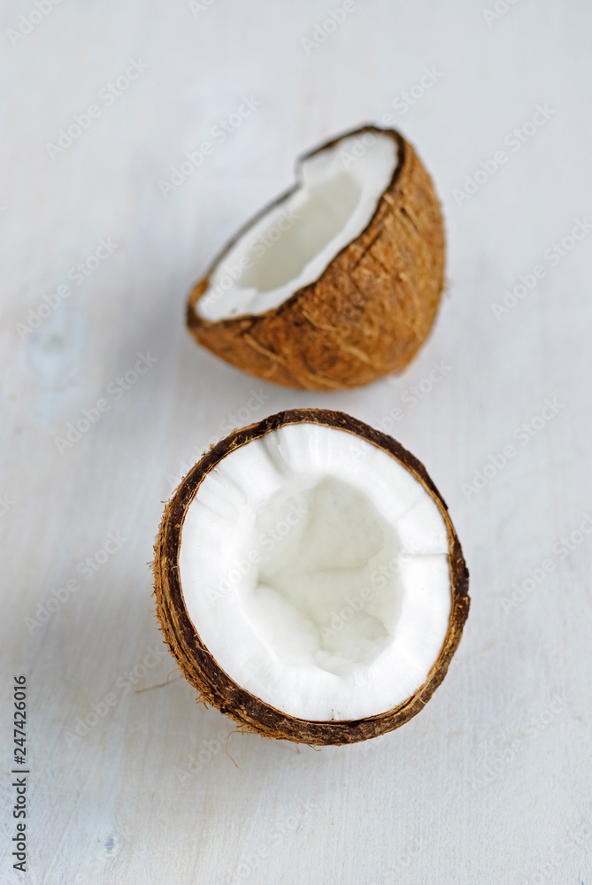 Ripe cracked coconut on grey background Ripe cracked coconut on grey background
