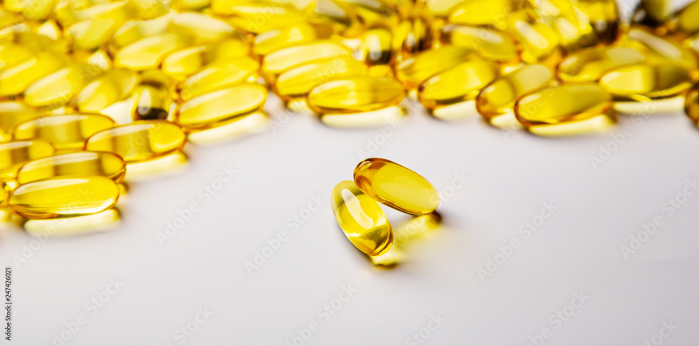 Omega-3 fish fat oil capsules on a white background. Omega-3 fish fat oil capsules on a white background.