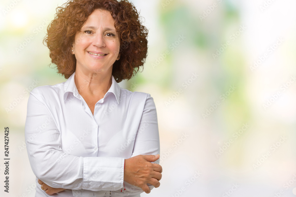Beautiful middle ager senior businees woman over isolated background happy face smiling with crossed arms looking at the camera. Positive person. Beautiful middle ager senior businees woman over isolated background happy face smiling with crossed arms looking at the camera. Positive person.