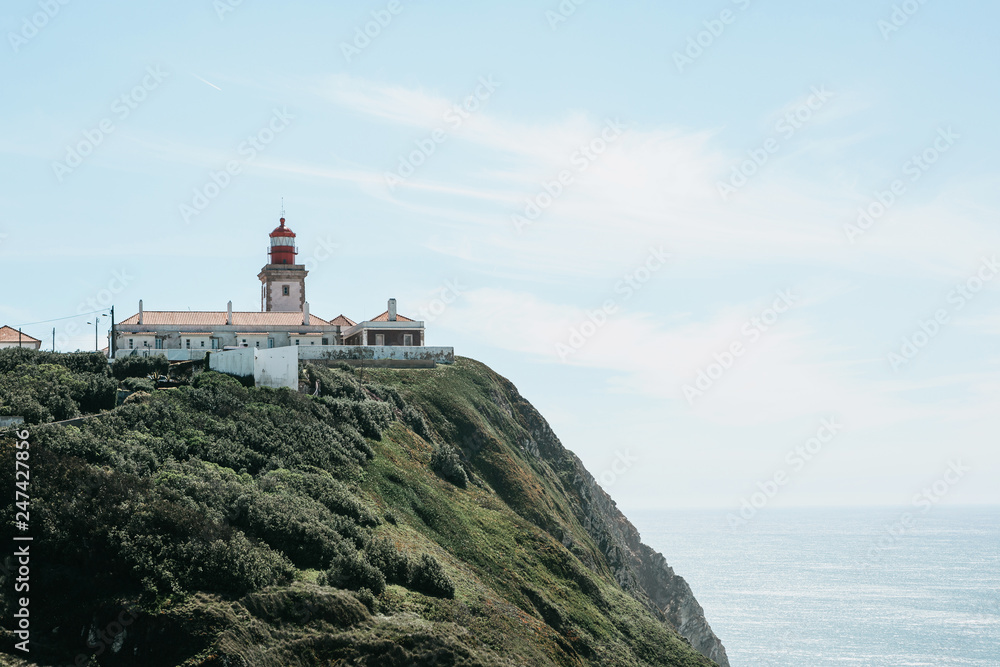Beautiful view of the lighthouse and the natural landscape at Cape Roca in Portugal on a sunny day