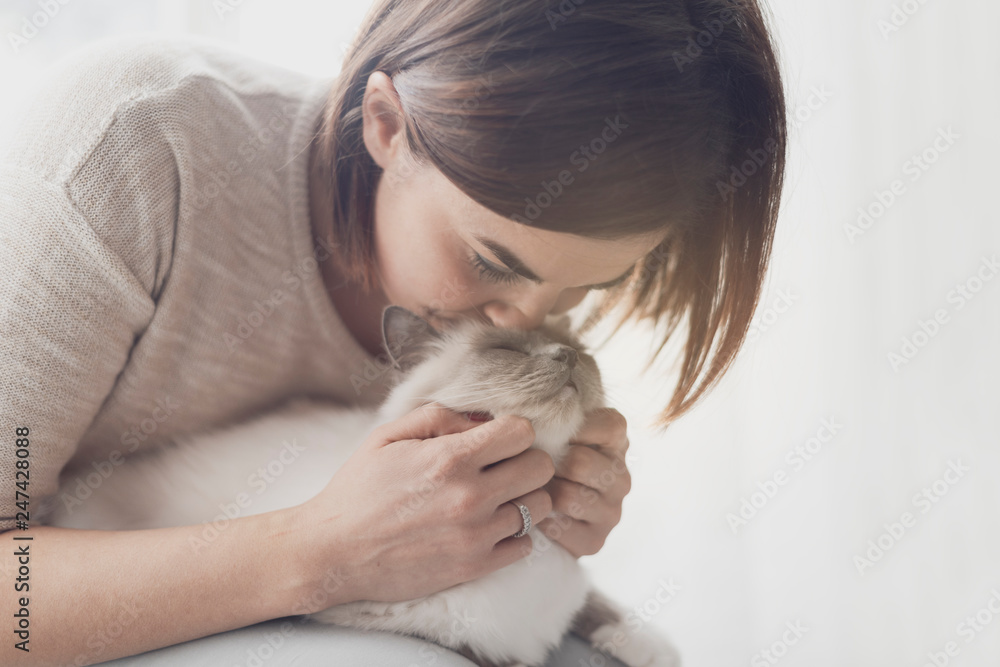 Woman hugging and petting her cat