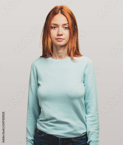 portrait of a pretty redhead girl standing photo